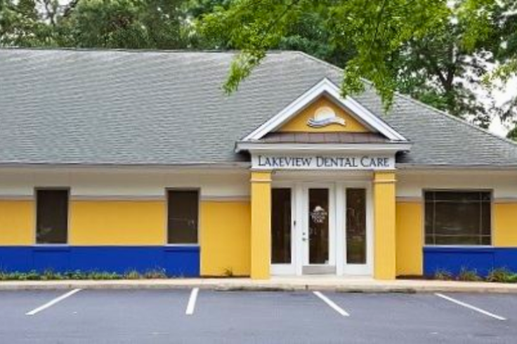 The front exterior of Lakeview Dental Care, featuring a yellow and blue building with a peaked roof and a welcoming entrance.